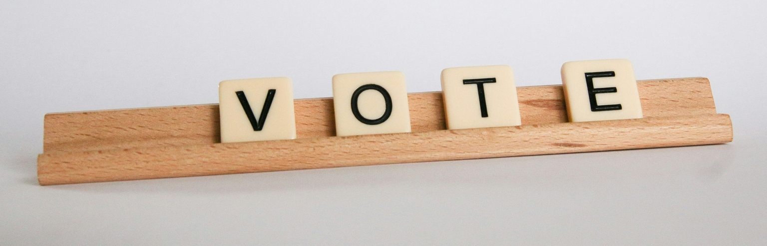 Scrabble tiles spelling out vote