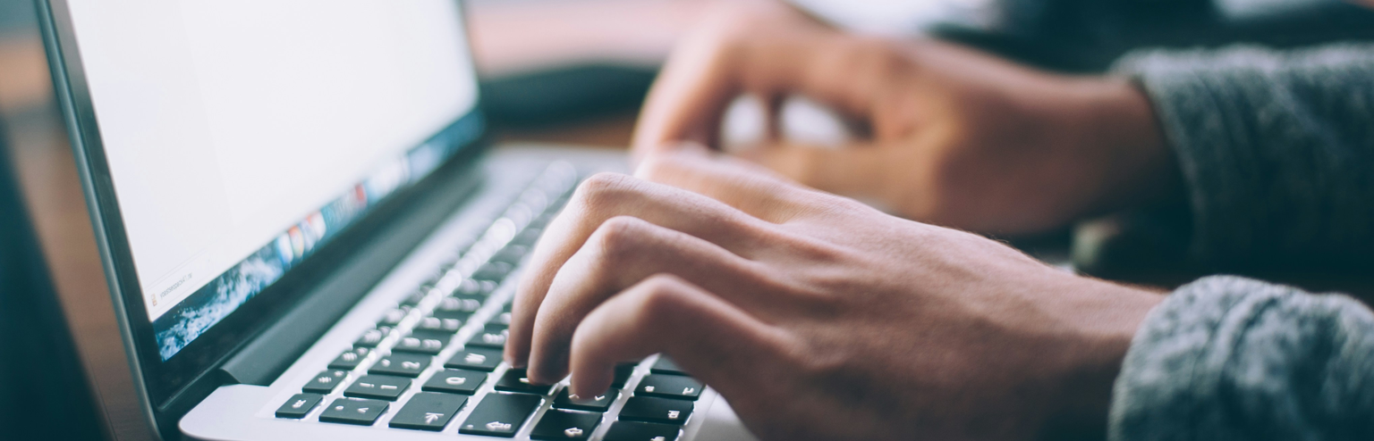 Typing into HOA management software on a computer