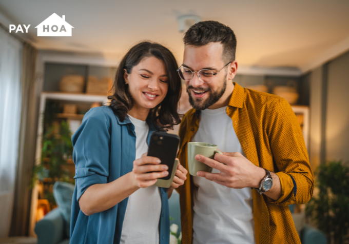 Pay HOA Blog - Stay Connected - Header A couple uses their HOA app to stay up to date with their neighborhood.